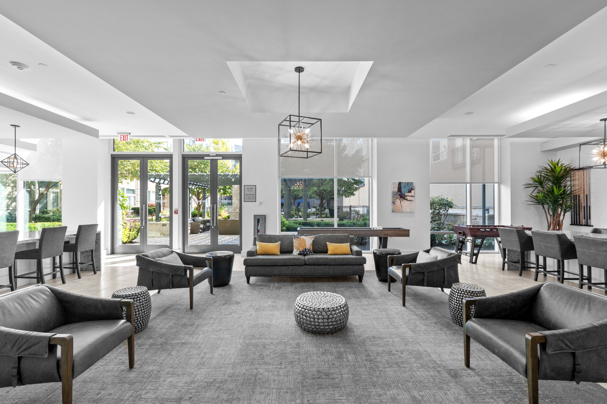 a large living room with couches and chairs and a table and chairs in front